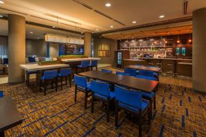 a restaurant with tables and chairs and a bar at Courtyard by Marriott Reno Downtown/Riverfront in Reno