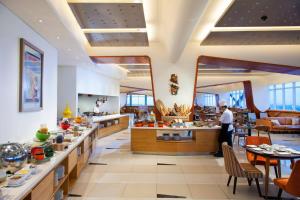 a restaurant with a person standing in a kitchen at Fairfield by Marriott Surabaya in Surabaya