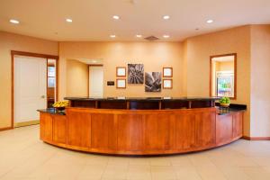 a large lobby with a large wooden reception desk at Residence Inn Phoenix Goodyear in Goodyear