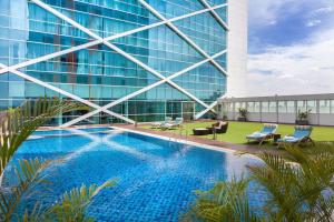 a swimming pool in front of a building at Fairfield by Marriott Surabaya in Surabaya