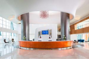 a lobby with two people sitting at a reception desk at Fairfield by Marriott Surabaya in Surabaya