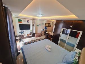 a small bedroom with a bed and a mirror at Italian Inspired Tropical-Themed Studio Condo in Davao City +30 photos