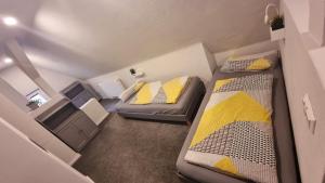 ein kleines Zimmer mit 2 Betten und einem Sofa in der Unterkunft Haus Erdmann in Dahn