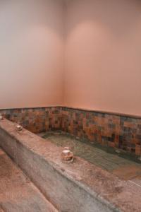 a pool of water in a room with a wall at Principe Alogna Hotel & SPA in Altavilla Milicia
