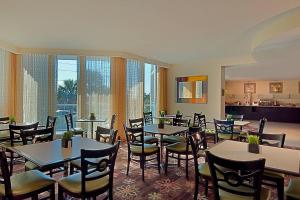 a restaurant with tables and chairs and a large window at Residence Inn by Marriott St. Petersburg Treasure Island in St. Pete Beach