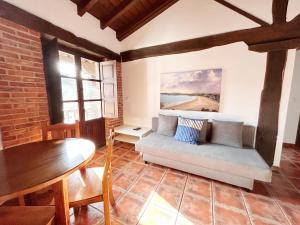 a living room with a couch and a table at Apartamentos Camino del Norte in Cóbreces