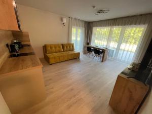 a living room with a couch and a table at Optimus Residence in Balatonföldvár