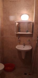 a bathroom with a sink and a mirror and a toilet at ЖК Sunshine&lov Апартамент Релакс in Kranevo +10 photos