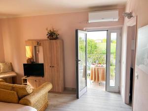 a living room with a television and a sliding glass door at (Via Francigena) La Casa Di Danilo in Spianate