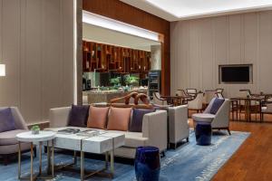 a lobby with a couch and chairs and tables at Courtyard by Marriott Yinchuan in Yinchuan