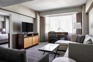 a hotel room with a couch and a television at San Francisco Marriott Union Square in San Francisco