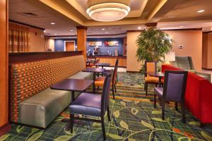 a restaurant with tables and chairs and a bar at Fairfield Inn and Suites by Marriott Laramie in Laramie