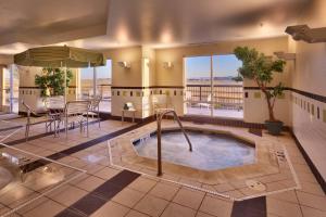 a pool in the middle of a room with a table and chairs at Fairfield Inn and Suites by Marriott Laramie in Laramie