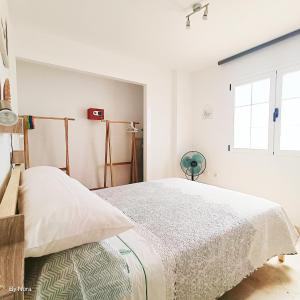 a white bedroom with a bed and a window at Apartment Las Arenas - Las Casas de Aron in Caleta De Fuste +20 photos