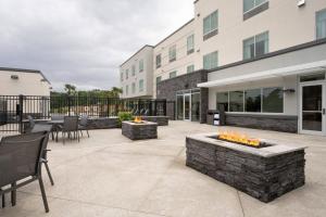 an outdoor patio with a fire pit with candles at Fairfield Inn & Suites Arkadelphia in Arkadelphia