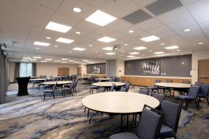 a classroom with tables and chairs and a chalkboard at Fairfield Inn & Suites Arkadelphia in Arkadelphia