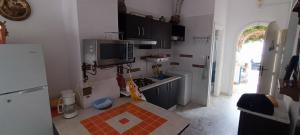 a small kitchen with a sink and a microwave at Résidence meriem 2 in Hammamet