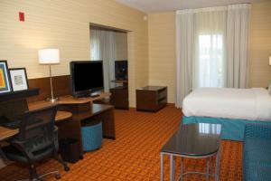 a hotel room with a bed and a desk with a computer at Fairfield Inn & Suites by Marriott Watervliet St. Joseph in Watervliet