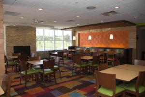 a restaurant with tables and chairs in a room at Comfort Inn & Suites in Watervliet