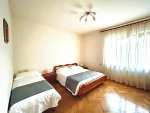 una camera con 2 letti e un ventilatore a soffitto di Appartamento L'arancio a Recanati