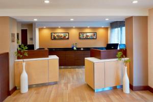 an office with two white vases in a lobby at Fairfield Inn by Marriott Rochester East in Webster