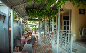 a patio of a restaurant with tables and chairs at Hotel Kingdom Appartments in Mwanza