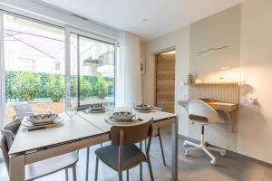 a dining room with a table and chairs and a window at At home in Clermont in Clermont-Ferrand