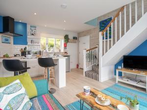 a kitchen and living room with blue walls at Blue Waters in Weymouth