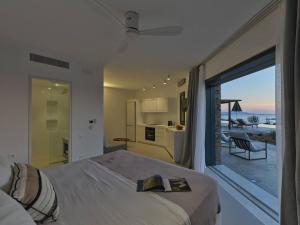 a bedroom with a bed and a view of the ocean at Olithos Villas in Krotiri