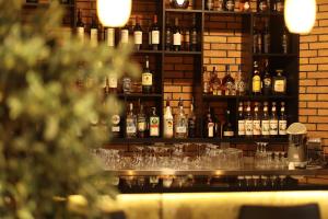 a bar with many bottles of alcohol and glasses at KOMOREBI BAKURIANI RESORT in Bakuriani