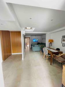 a living room with a table and a couch at Attic apartment in old town in Denia