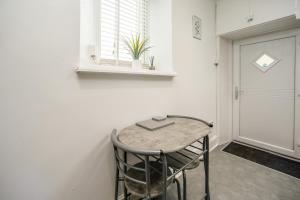 a small table with a book on it in a room at Cottage hide-out in Kirkheaton