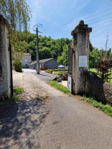 um velho edifício de pedra no lado de uma estrada em moulin de rouchillou em Saint-Martial-de-Valette