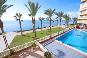 an aerial view of a resort with a swimming pool and palm trees at Las Gemelas Apartments in La Manga del Mar Menor