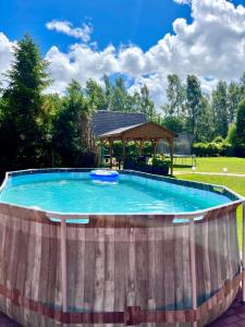 a large plunge pool with a gazebo at Domek letniskowy Sport&Relax in Kopalino