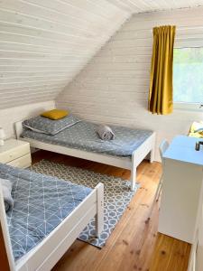 a room with two bunk beds in a attic at Domek letniskowy Sport&Relax in Kopalino
