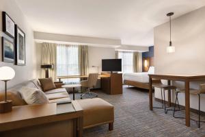 a hotel room with a couch and a bed at Residence Inn Sacramento Folsom in Folsom