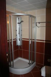 a shower stall in a bathroom with red tile at CihanTürk Hotel in Marmaris