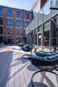 two chairs sitting on a patio in front of a building at VICTORIA Hotel Kaunas in Kaunas