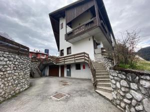 a building with stairs and a balcony on it at Casa Marmarole in Borca di Cadore