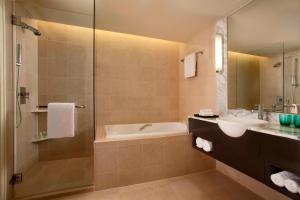 a bathroom with a tub and a sink and a shower at The Westin Kuala Lumpur in Kuala Lumpur