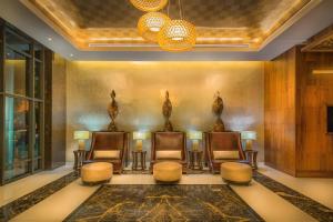 a lobby with three chairs and a table and lights at JW Marriott Hotel Santo Domingo in Santo Domingo