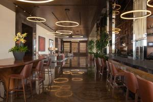 a bar with chairs and tables in a restaurant at JW Marriott Hotel Santo Domingo in Santo Domingo
