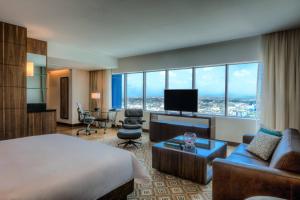 a hotel room with a bed and a desk and a room at JW Marriott Hotel Santo Domingo in Santo Domingo
