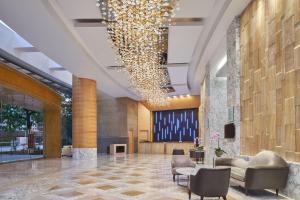 a lobby with chairs and a large chandelier at The Westin Kuala Lumpur in Kuala Lumpur