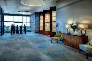 a group of people standing in a lobby looking out the window at JW Marriott Hotel Santo Domingo in Santo Domingo +37 photos