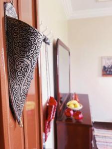 a black and white umbrella hanging on a door at Dar Sakina with Private Pool in Oulad Zenati