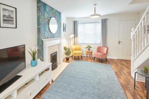 a living room with a tv and a fireplace at Host & Stay - Garden Cottage in Durham