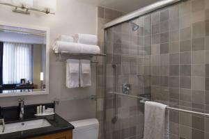 a bathroom with a shower and a toilet and a sink at Fairfield Inn & Suites by Marriott New York Manhattan/Fifth Avenue in New York