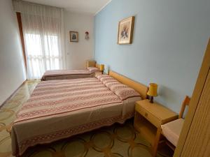 Ένα ή περισσότερα κρεβάτια σε δωμάτιο στο Condominio Simma